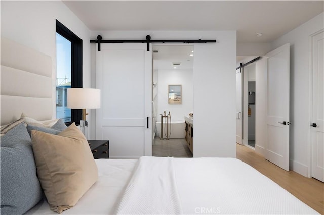 1315 Ocean Ave, Seal Beach, CA 90740 - bedroom with a barn door and light wood-style flooring