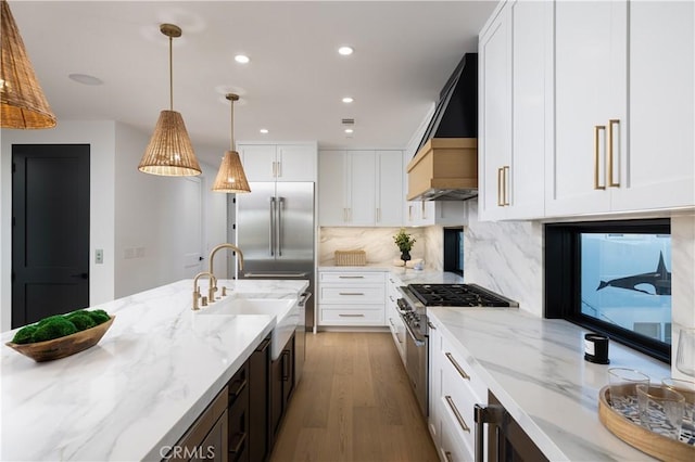 1315 Ocean Ave, Seal Beach, CA 90740 - kitchen with wood finished floors, white cabinetry, decorative backsplash, high end range, and hanging light fixtures