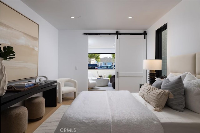 1315 Ocean Ave, Seal Beach, CA 90740 - bedroom featuring a barn door, wood finished floors, and recessed lighting
