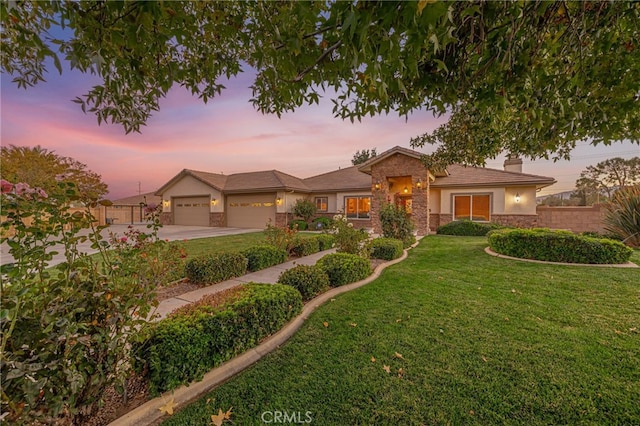 2534 Desert Rose Dr, Lancaster, CA 93536 - view of front facade with driveway, stucco siding, an attached garage, stone siding, and a chimney
