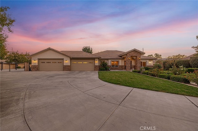 2534 Desert Rose Dr, Lancaster, CA 93536 - view of front of property featuring concrete driveway, an attached garage, stone siding, and stucco siding