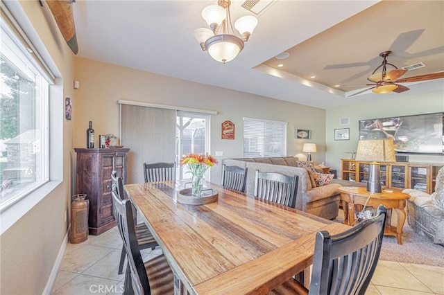 2534 Desert Rose Dr, Lancaster, CA 93536 - dining area featuring light tile patterned flooring, a chandelier, ceiling fan, a tray ceiling, and recessed lighting