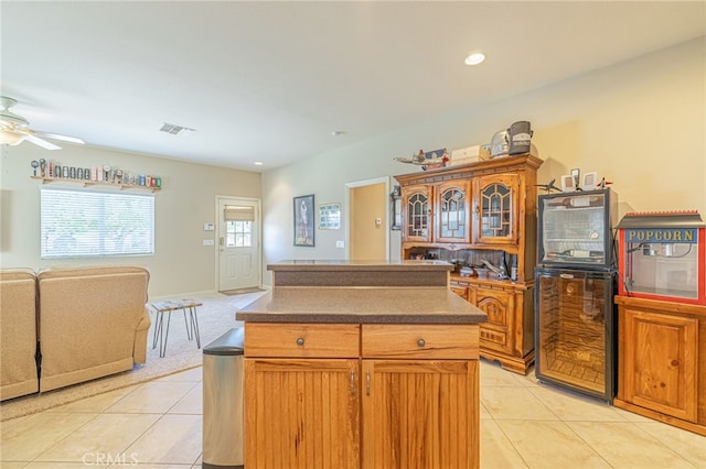 2534 Desert Rose Dr, Lancaster, CA 93536 - kitchen with open floor plan, light tile patterned flooring, a center island, dark countertops, and a ceiling fan