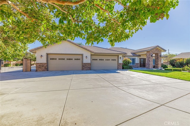 2534 Desert Rose Dr, Lancaster, CA 93536 - view of front facade featuring stucco siding, concrete driveway, stone siding, and an attached garage