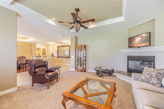 2534 Desert Rose Dr, Lancaster, CA 93536 - carpeted living area with a tray ceiling, a ceiling fan, a glass covered fireplace, recessed lighting, and ornamental molding