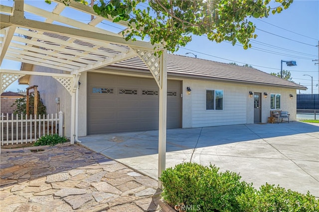 2534 Desert Rose Dr, Lancaster, CA 93536 - view of front of home featuring driveway, stucco siding, a tiled roof, a pergola, and a garage