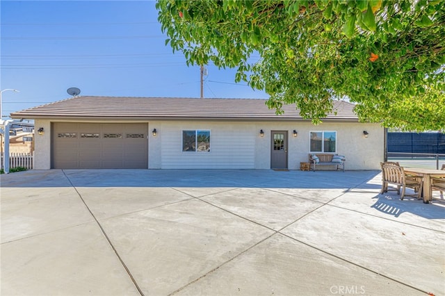 2534 Desert Rose Dr, Lancaster, CA 93536 - ranch-style house featuring a garage, stucco siding, concrete driveway, a tiled roof, and a patio