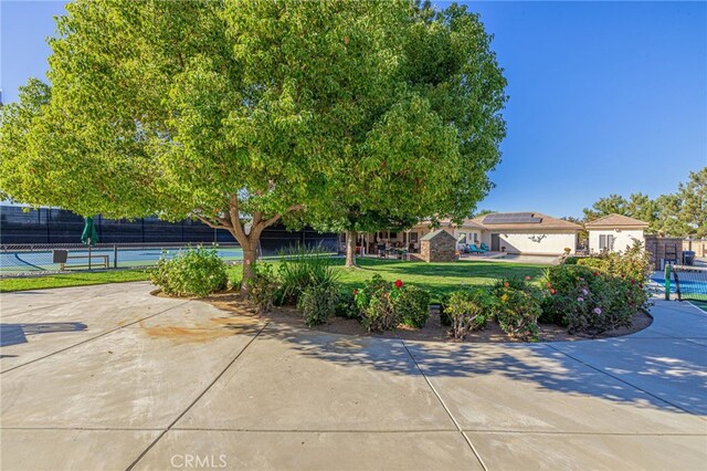 2534 Desert Rose Dr, Lancaster, CA 93536 - view of front of house with a tennis court and solar panels
