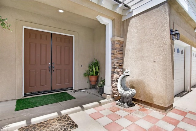 26810 Sugarite Canyon Dr, Moreno Valley, CA 92555 - property entrance with stucco siding, a garage, and stone siding