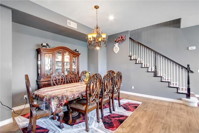 26810 Sugarite Canyon Dr, Moreno Valley, CA 92555 - dining space with a chandelier, wood finished floors, and stairway
