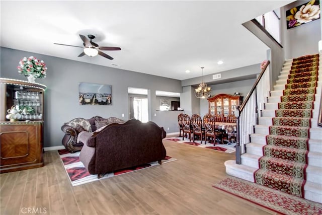 26810 Sugarite Canyon Dr, Moreno Valley, CA 92555 - living area with a chandelier, ceiling fan, stairway, wood finished floors, and recessed lighting