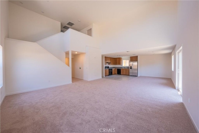 363 Arpent Ct, Merced, CA 95341 - unfurnished living room featuring light carpet and high vaulted ceiling