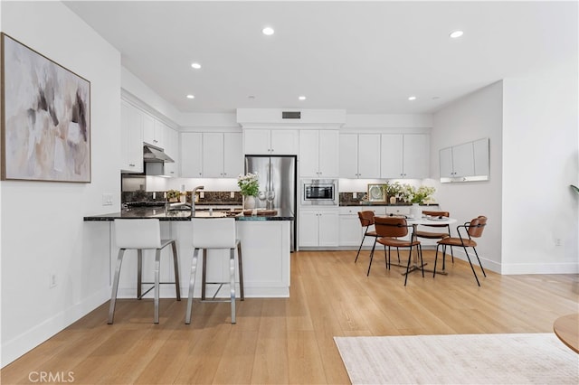 186 Bishop Lndg, Irvine, CA 92620 - kitchen featuring stainless steel appliances, a peninsula, white cabinets, recessed lighting, and dark countertops