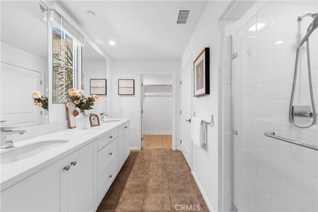 186 Bishop Lndg, Irvine, CA 92620 - bathroom featuring double vanity, a stall shower, a spacious closet, and recessed lighting