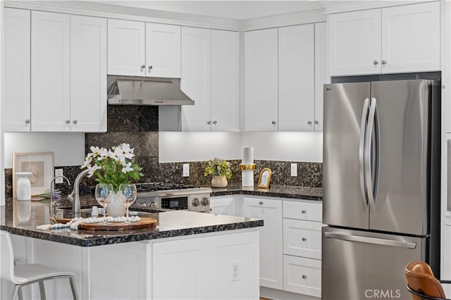 186 Bishop Lndg, Irvine, CA 92620 - kitchen with appliances with stainless steel finishes, under cabinet range hood, a peninsula, white cabinetry, and dark stone counters
