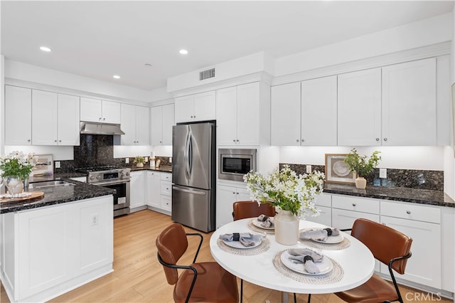 186 Bishop Lndg, Irvine, CA 92620 - kitchen featuring appliances with stainless steel finishes, under cabinet range hood, white cabinetry, light wood-type flooring, and recessed lighting
