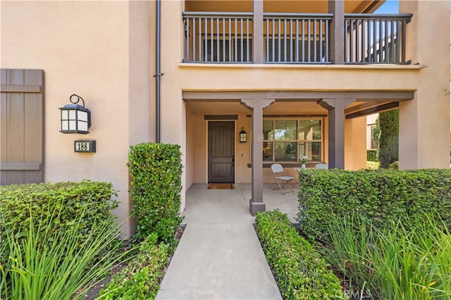 186 Bishop Lndg, Irvine, CA 92620 - property entrance featuring stucco siding, a balcony, and a porch