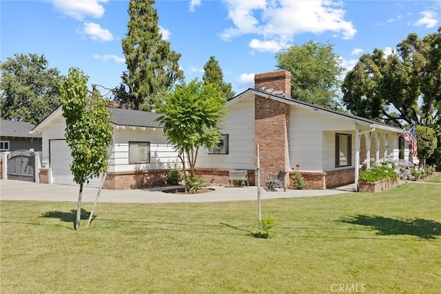 1094 Manzanita Ave, Chico, CA 95926 - view of front of property featuring brick siding, concrete driveway, a chimney, a front yard, and an attached garage