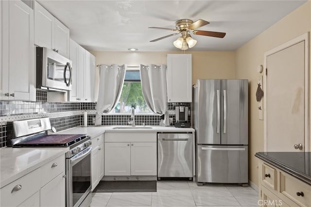 1094 Manzanita Ave, Chico, CA 95926 - kitchen featuring stainless steel appliances, ceiling fan, tasteful backsplash, and white cabinets