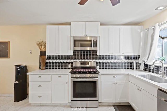 1094 Manzanita Ave, Chico, CA 95926 - kitchen featuring stainless steel appliances, decorative backsplash, white cabinetry, and light countertops