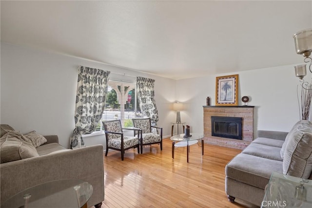 1094 Manzanita Ave, Chico, CA 95926 - living room featuring light wood-type flooring and a brick fireplace