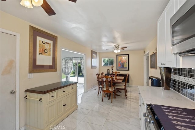1094 Manzanita Ave, Chico, CA 95926 - dining room featuring ceiling fan and light marble finish flooring