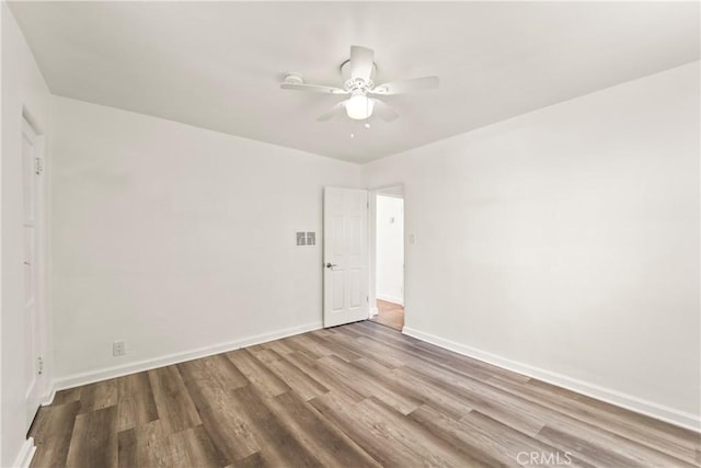 8727 S Harvard Blvd, Los Angeles, CA 90047 - unfurnished room with wood finished floors and ceiling fan