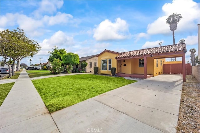 8727 S Harvard Blvd, Los Angeles, CA 90047 - view of front of property featuring concrete driveway, a tiled roof, stucco siding, and a carport