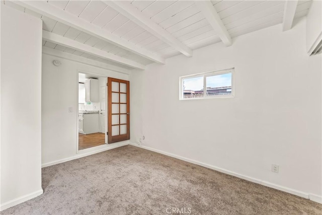 8727 S Harvard Blvd, Los Angeles, CA 90047 - carpeted spare room with a wood ceiling with exposed beams