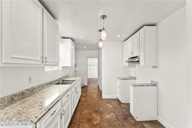 8727 S Harvard Blvd, Los Angeles, CA 90047 - kitchen featuring under cabinet range hood, light countertops, white cabinetry, and recessed lighting