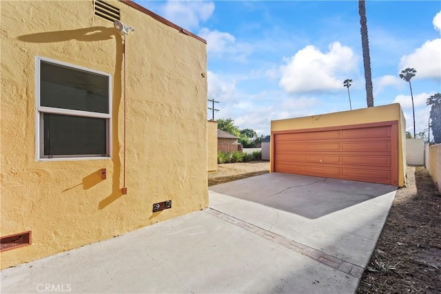 8727 S Harvard Blvd, Los Angeles, CA 90047 - view of property exterior with stucco siding and a detached garage