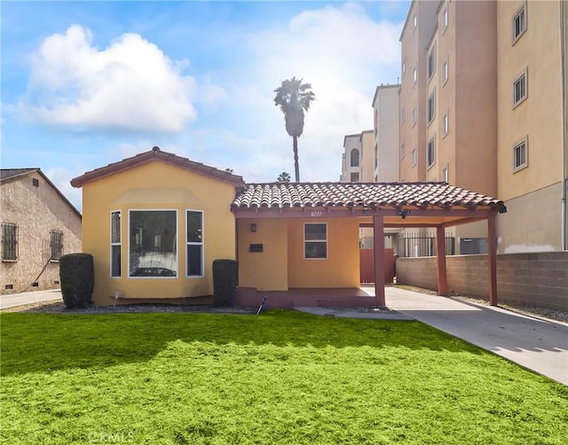 8727 S Harvard Blvd, Los Angeles, CA 90047 - back of property featuring a tile roof, stucco siding, and concrete driveway