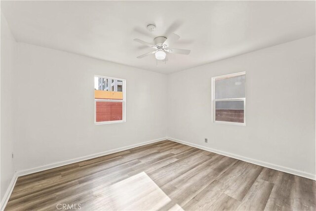 8727 S Harvard Blvd, Los Angeles, CA 90047 - empty room featuring wood finished floors, ceiling fan, and a smoke detector