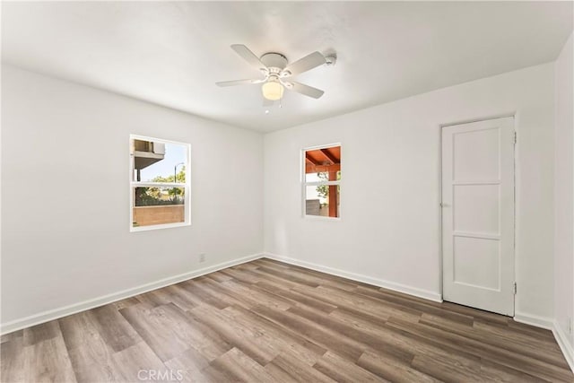 8727 S Harvard Blvd, Los Angeles, CA 90047 - unfurnished room featuring wood finished floors and a ceiling fan