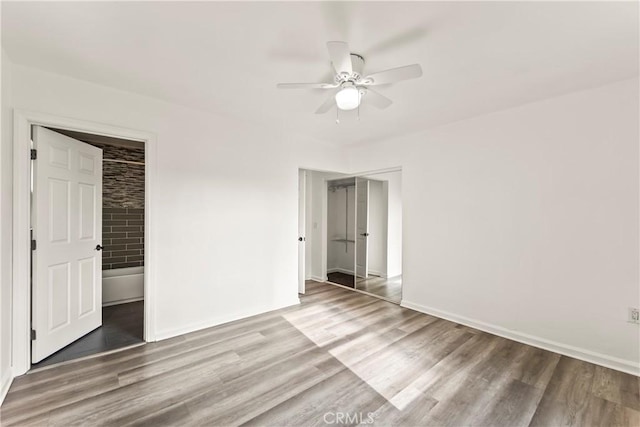 8727 S Harvard Blvd, Los Angeles, CA 90047 - unfurnished bedroom with wood finished floors and a ceiling fan