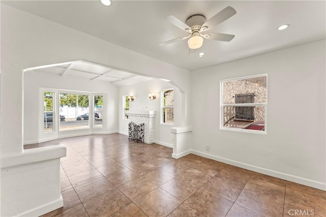 8727 S Harvard Blvd, Los Angeles, CA 90047 - unfurnished living room featuring recessed lighting, arched walkways, tile patterned floors, a ceiling fan, and beam ceiling