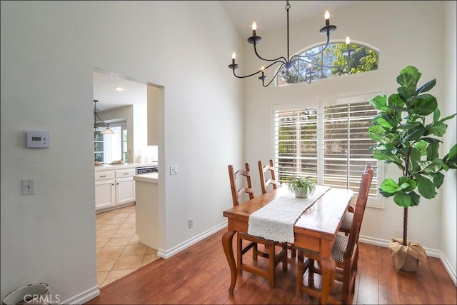 3 Blue Heron Ln, Aliso Viejo, CA 92656 - dining room featuring a towering ceiling, light wood finished floors, and a chandelier