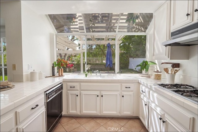 3 Blue Heron Ln, Aliso Viejo, CA 92656 - kitchen with black dishwasher, tile countertops, white cabinets, and light tile patterned flooring