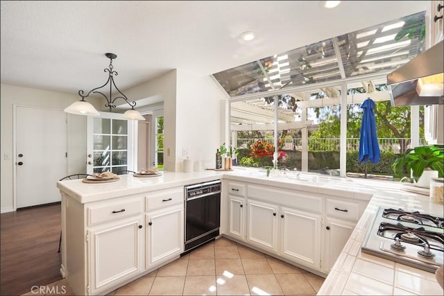 3 Blue Heron Ln, Aliso Viejo, CA 92656 - kitchen with black dishwasher, tile countertops, stainless steel gas cooktop, a peninsula, and white cabinets