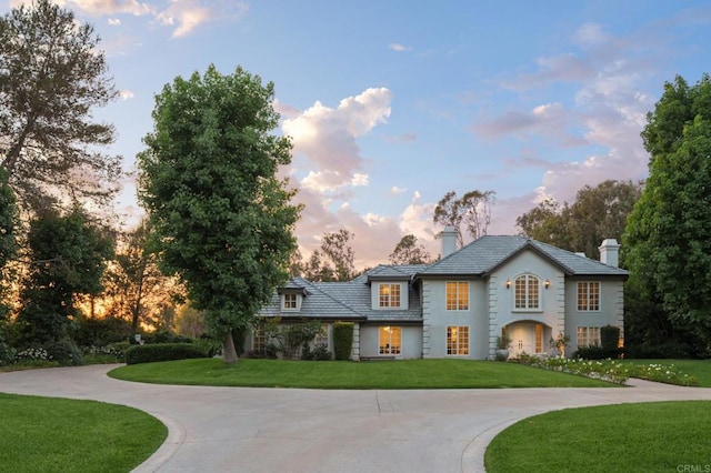 17274 Calle Mayor, Rancho Santa Fe, CA 92067 - view of front of home with a chimney, curved driveway, a lawn, and stucco siding