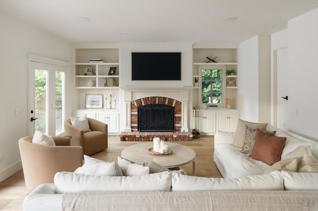 17274 Calle Mayor, Rancho Santa Fe, CA 92067 - living area with light wood finished floors, built in shelves, and a brick fireplace
