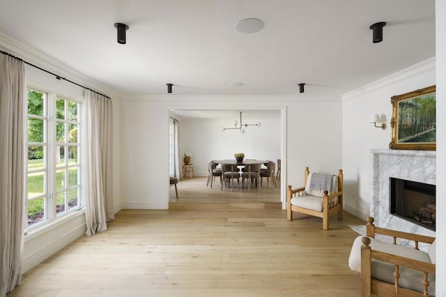 17274 Calle Mayor, Rancho Santa Fe, CA 92067 - living area featuring healthy amount of natural light, crown molding, light wood-style flooring, and a high end fireplace