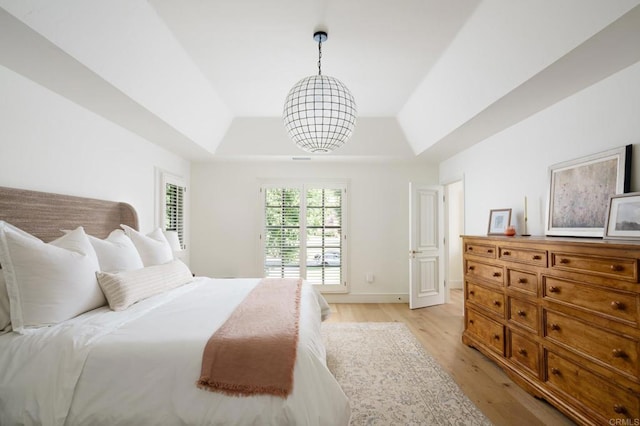 17274 Calle Mayor, Rancho Santa Fe, CA 92067 - bedroom featuring a raised ceiling, light wood finished floors, and a chandelier