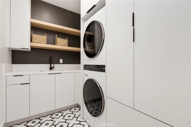 19031 Fowler Ave, North Tustin, CA 92705 - laundry area with stacked washer / drying machine, cabinet space, and light floors