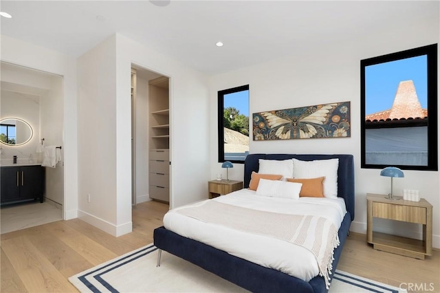 19031 Fowler Ave, North Tustin, CA 92705 - bedroom featuring a spacious closet, wood finished floors, recessed lighting, connected bathroom, and a closet