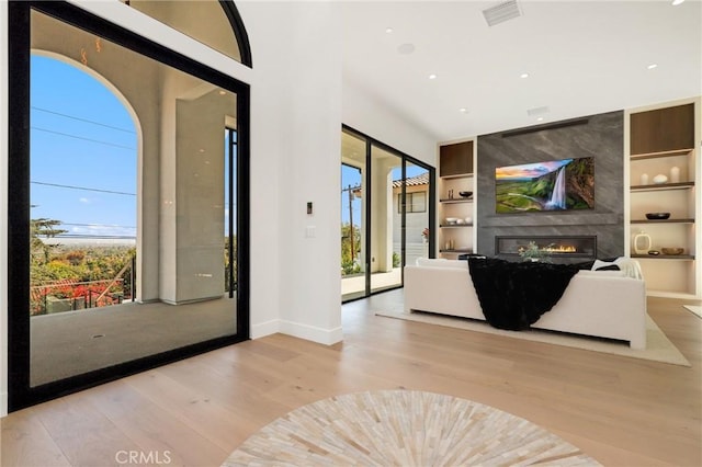19031 Fowler Ave, North Tustin, CA 92705 - living room with built in features, wood finished floors, a large fireplace, and recessed lighting