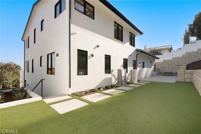 19031 Fowler Ave, North Tustin, CA 92705 - back of property featuring stucco siding, a patio area, and a yard