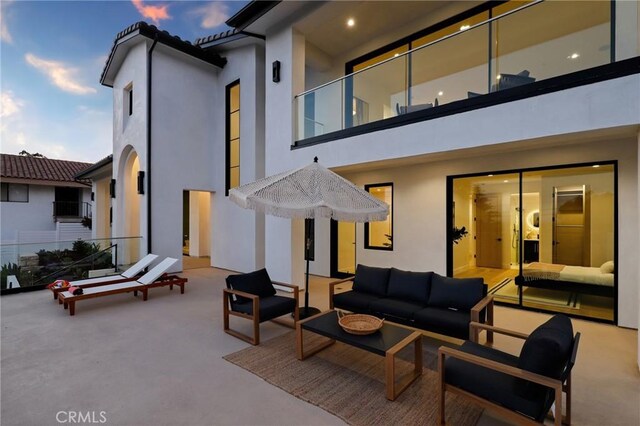19031 Fowler Ave, North Tustin, CA 92705 - back of property with outdoor lounge area, stucco siding, and a balcony