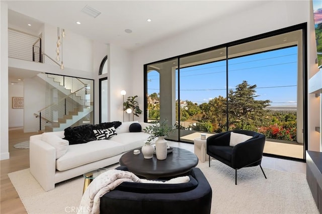 19031 Fowler Ave, North Tustin, CA 92705 - living room featuring healthy amount of natural light, stairway, wood finished floors, recessed lighting, and a towering ceiling