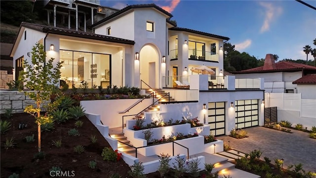 19031 Fowler Ave, North Tustin, CA 92705 - back of house with stairs, a balcony, driveway, a tile roof, and stucco siding